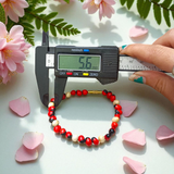 Natural Red and White Gunja seed bracelet with approx. 5mm beads, stretchable and lab certified, displayed on a white background
