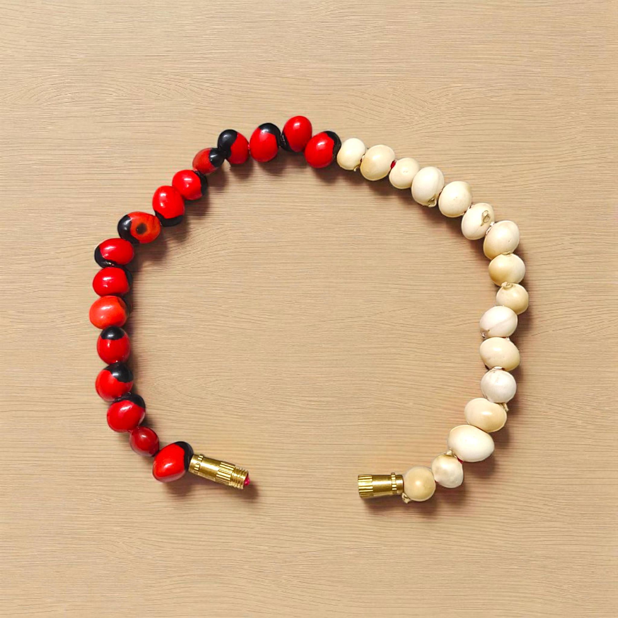 Natural Red and White Gunja seed bracelet with approx. 5mm beads, stretchable and lab certified, displayed on a white background