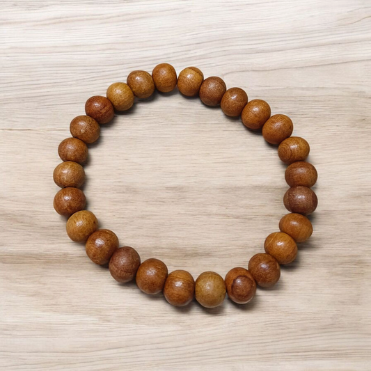 Natural White Sandalwood Bracelet with 8mm round stretchable beads, lab certified, displayed on a wooden surface