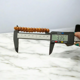 Natural White Sandalwood Bracelet with 8mm round stretchable beads, lab certified, displayed on a wooden surface