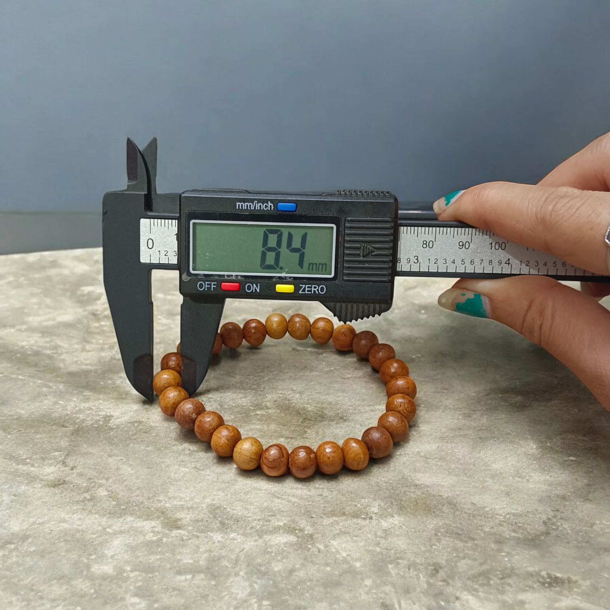Natural White Sandalwood Bracelet with 8mm round stretchable beads, lab certified, displayed on a wooden surface