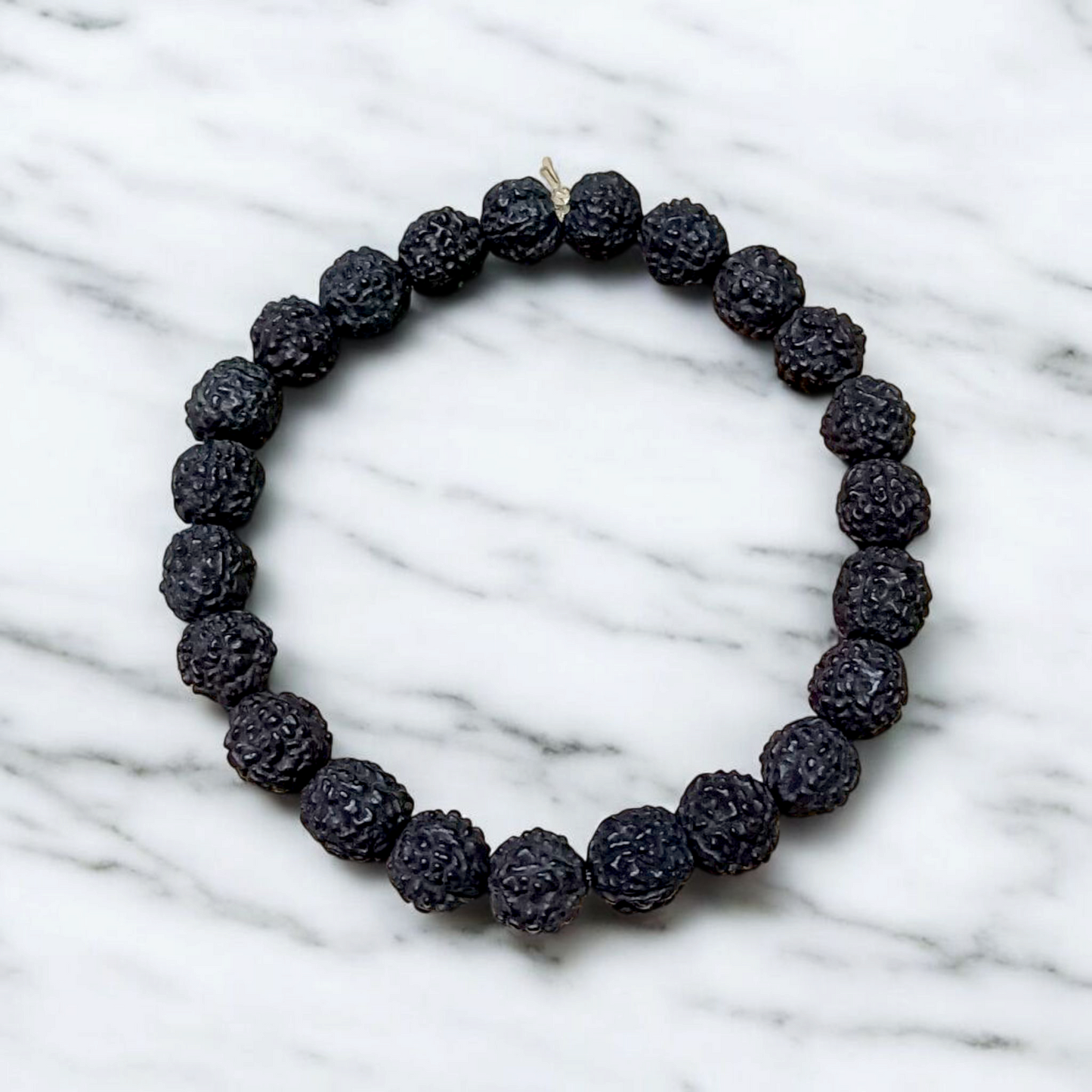 Natural black Rudraksha bracelet made with 8mm lab-certified beads, stretchable design displayed on a clean white surface