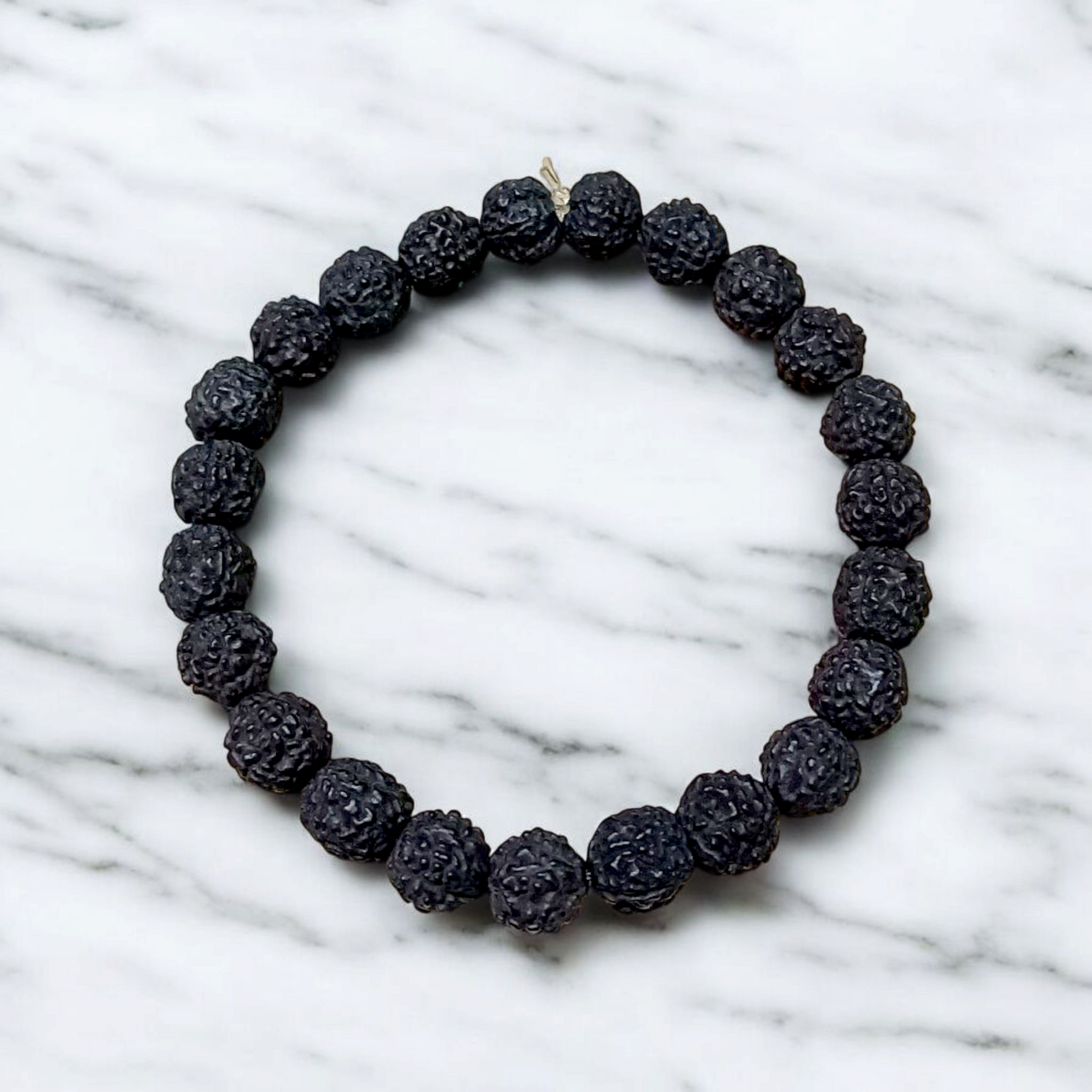 Natural black Rudraksha bracelet made with 8mm lab-certified beads, stretchable design displayed on a clean white surface