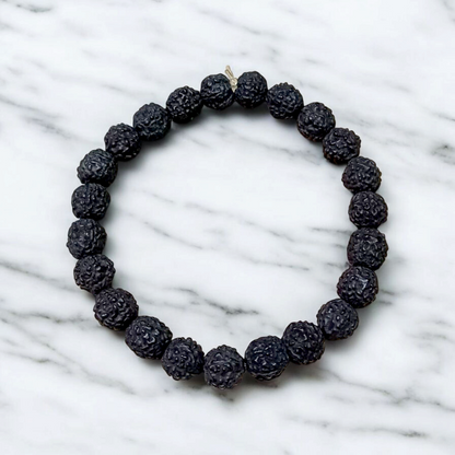 Natural black Rudraksha bracelet made with 8mm lab-certified beads, stretchable design displayed on a clean white surface