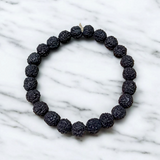 Natural black Rudraksha bracelet made with 8mm lab-certified beads, stretchable design displayed on a clean white surface