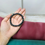 Natural black Rudraksha bracelet made with 8mm lab-certified beads, stretchable design displayed on a clean white surface