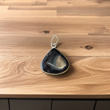 Natural lab certified Sulemani Hakik pendant with black and grey bands, fitted in a wearable setting for healing and protection
