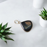 Natural lab certified Sulemani Hakik pendant with black and grey bands, fitted in a wearable setting for healing and protection