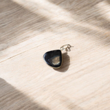 Natural lab certified Sulemani Hakik pendant with black and grey bands, fitted in a wearable setting for healing and protection