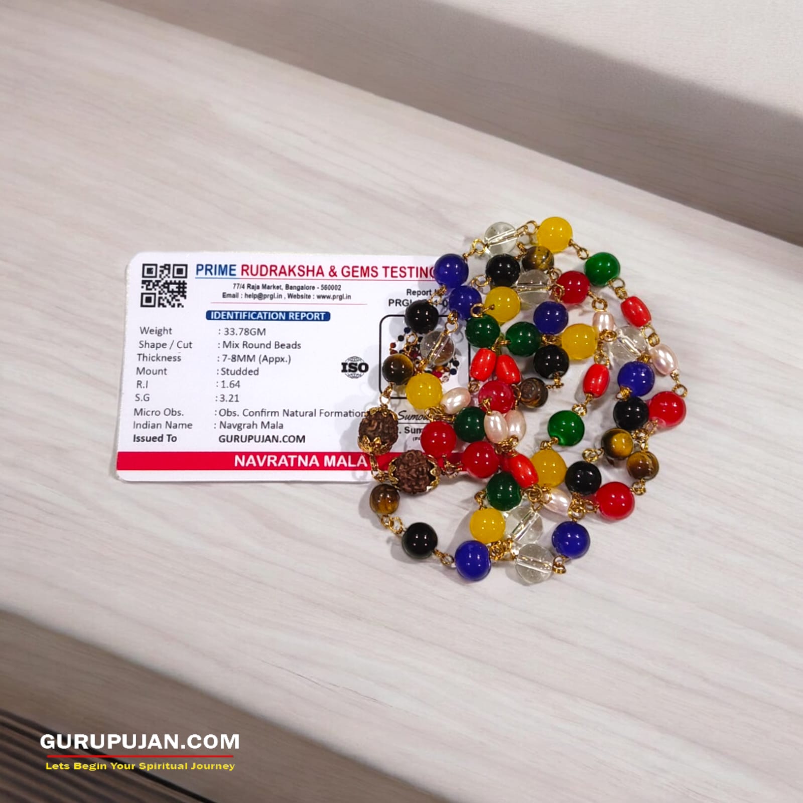 Navratan Mala made with 9 natural gemstones, featuring Rudraksha closure, ideal for planetary balance and prosperity.