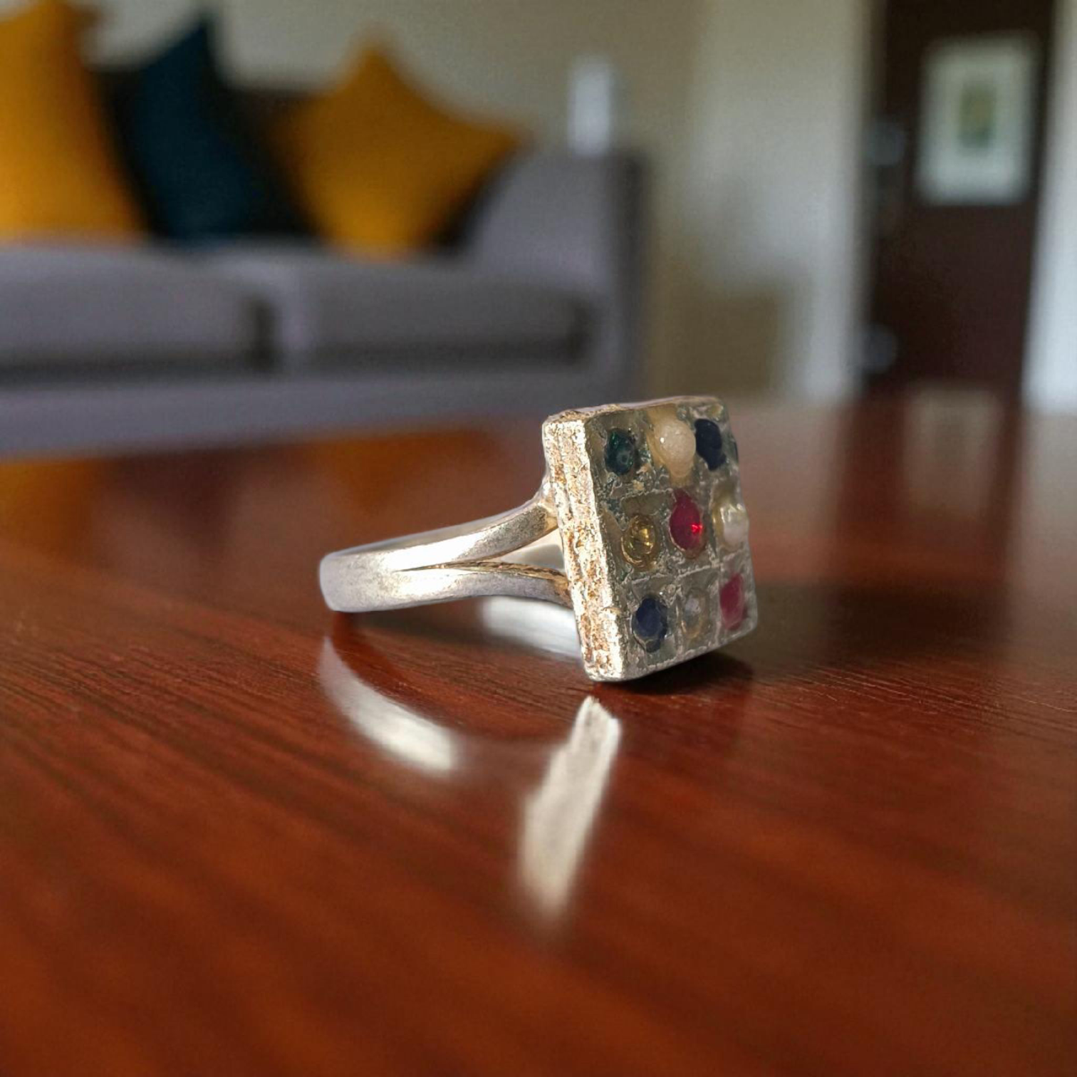 Navratan Ring Square Shape – Spiritual and astrological ring featuring nine gemstones for prosperity, health, and protection.