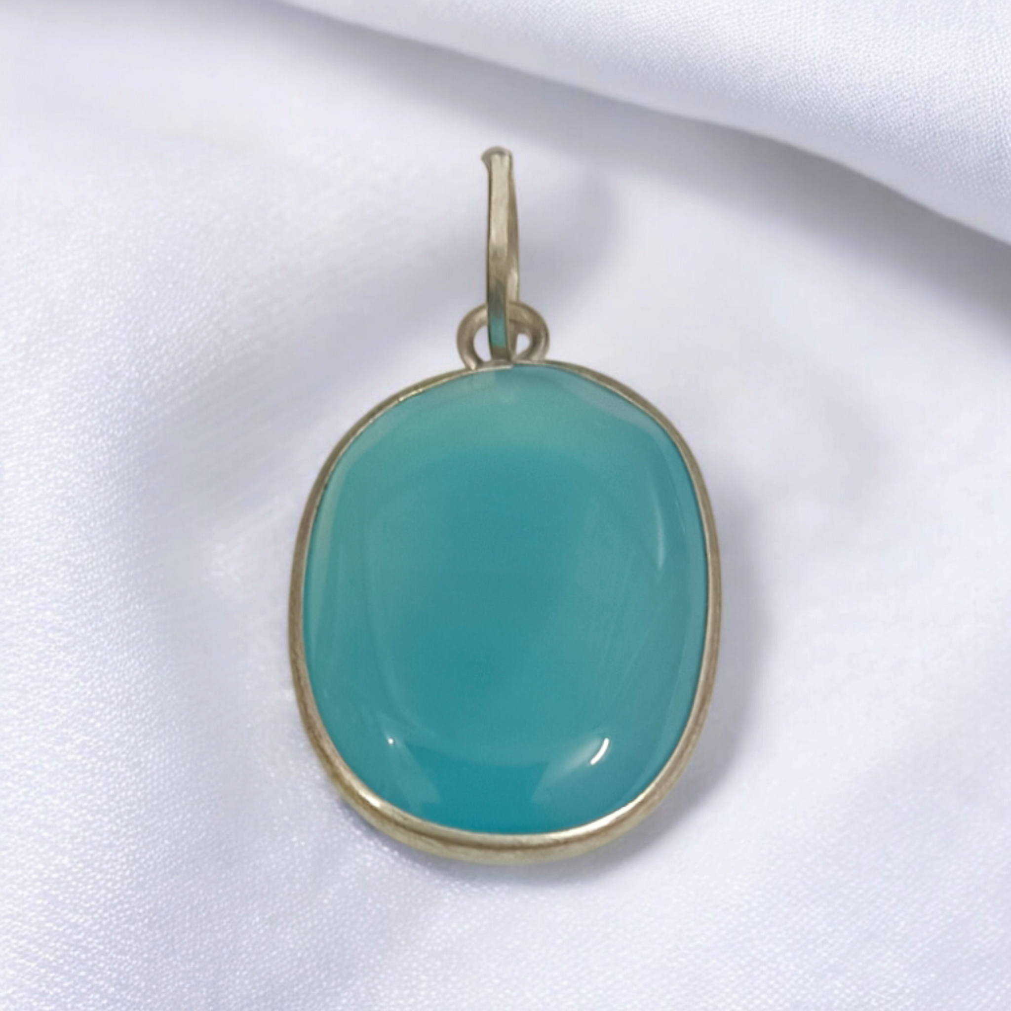 Original Firoza pendant with a vibrant turquoise hue, displayed on a necklace, highlighting its polished finish and elegant design.