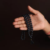 Original Lava Mala made of pure black lava beads for meditation and career stability – available in 27+1 and 108+1 bead variants.