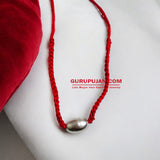 Parad Gutika locket crafted from pure mercury, featuring Lord Shiva’s image, with a red knotted thread for easy wear.