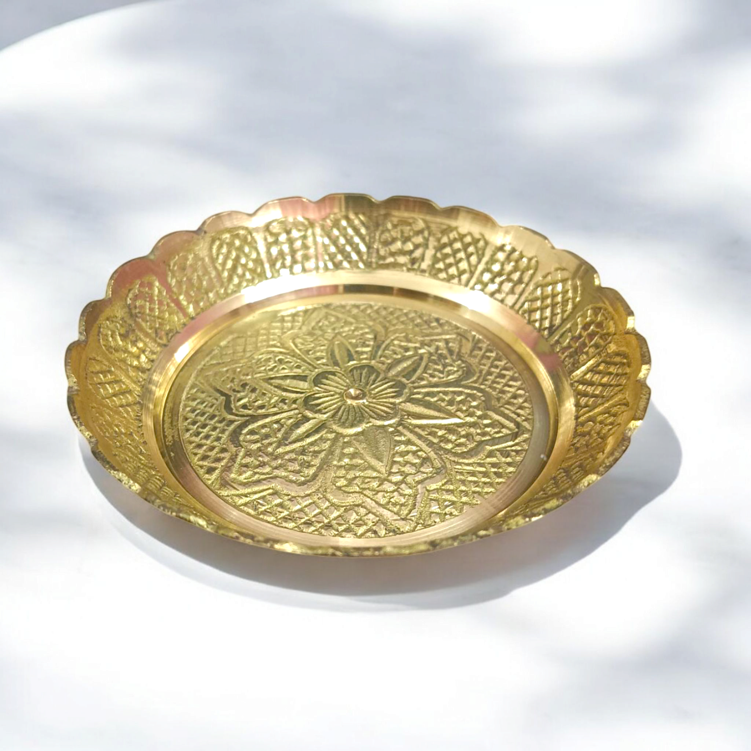 Pure brass flower design plate for temple use, ideal for holding lamps, idols, and religious offerings during pooja ceremonies.

