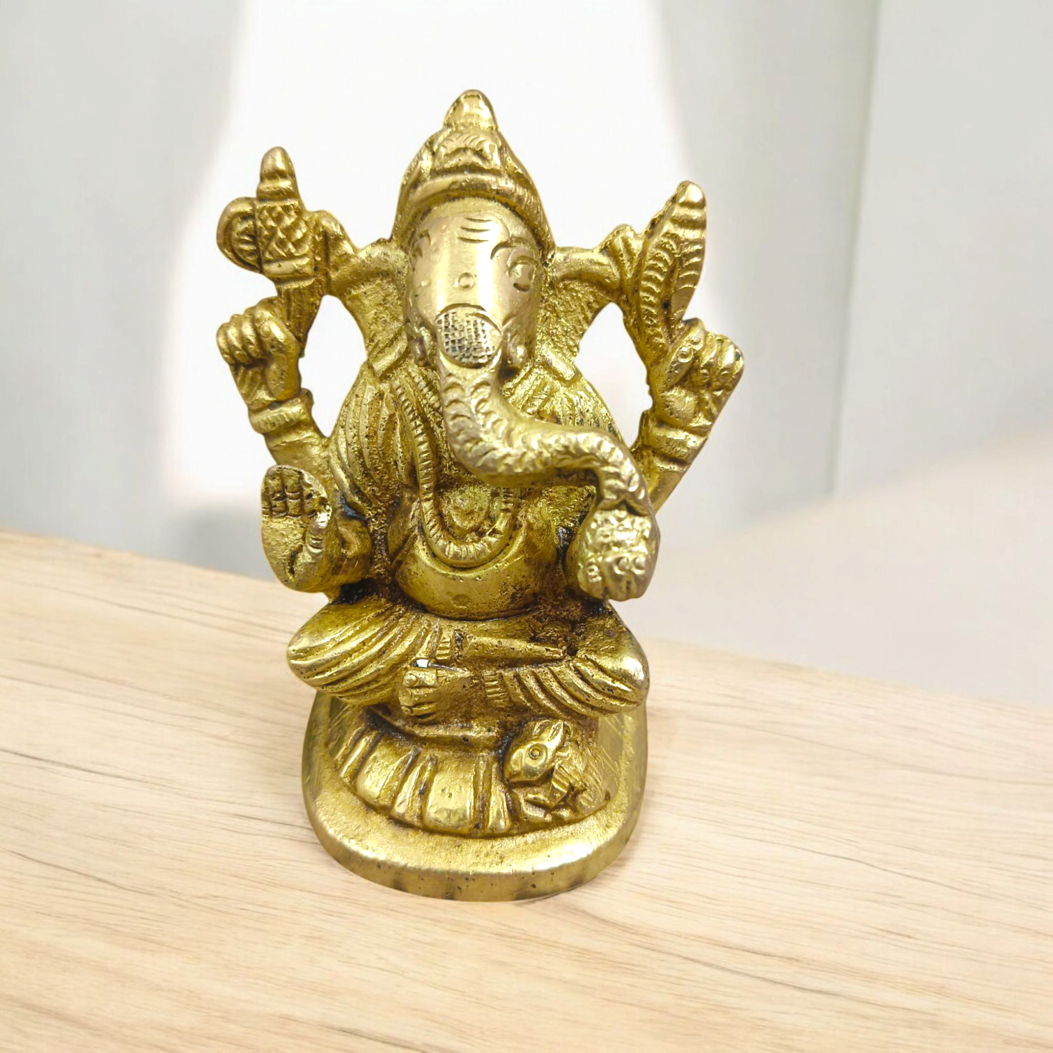 Pure brass statue of Lord Ganesha, intricately designed with details symbolizing wisdom, prosperity, and the removal of obstacles.