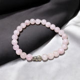 Rose Quartz Bracelet with 8mm natural pink beads, stretchable, lab certified, displayed on a neutral background