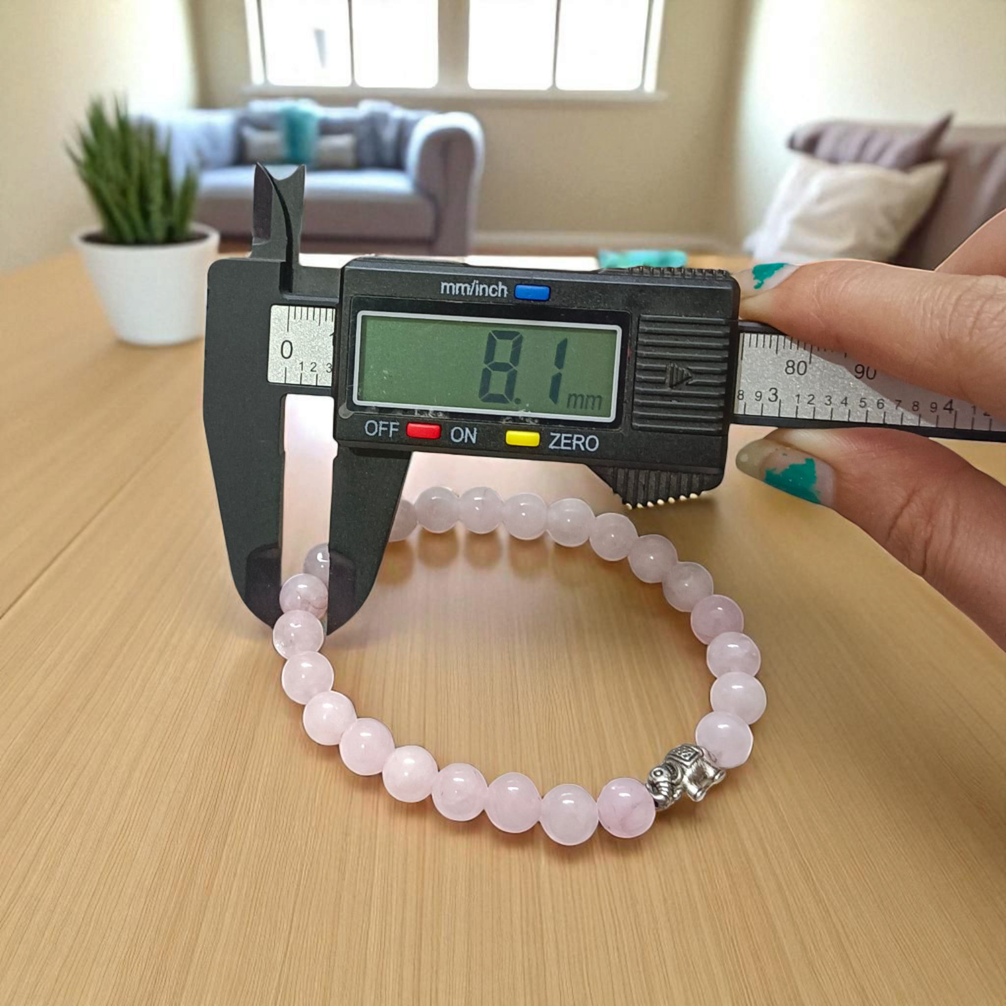 Rose Quartz Bracelet with 8mm natural pink beads, stretchable, lab certified, displayed on a neutral background
