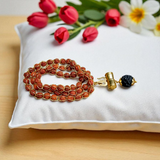 Rudraksha Mala with Gold Wired Design and Trishul Locket, offering divine protection and spiritual blessings from Lord Shiva