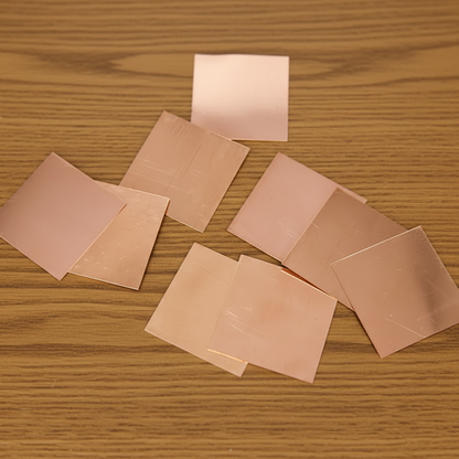 Set of 11 Copper Square Pieces (Copper Patra) used for Vastu correction, spiritual rituals, and energy enhancement.