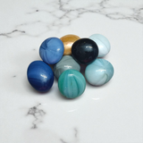 Set of 8 multicolor shiny round glass pebble stones placed in plant pots, vases, and aquariums
