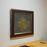 Shree Yantra mounted on raw Pyrite crystal in a wooden Vastu-compliant photo frame for spiritual home and office décor