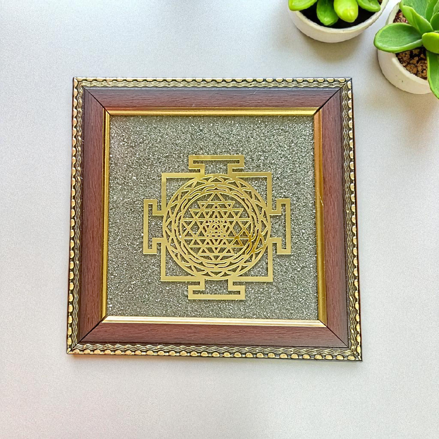 Shree Yantra mounted on raw Pyrite crystal in a wooden Vastu-compliant photo frame for spiritual home and office décor