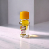 Small 2ML glass bottle of premium natural OUD Attar by Veena with elegant packaging, ideal for daily and spiritual use