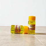 Small 4ML glass roll-on bottle of natural Sandal Attar (Chandan Itra) by Veena, perfect for spiritual rituals, meditation, and daily wear