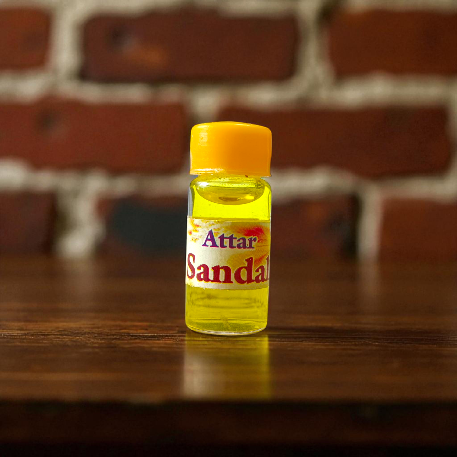 Small 4ML glass roll-on bottle of natural Sandal Attar (Chandan Itra) by Veena, perfect for spiritual rituals, meditation, and daily wear