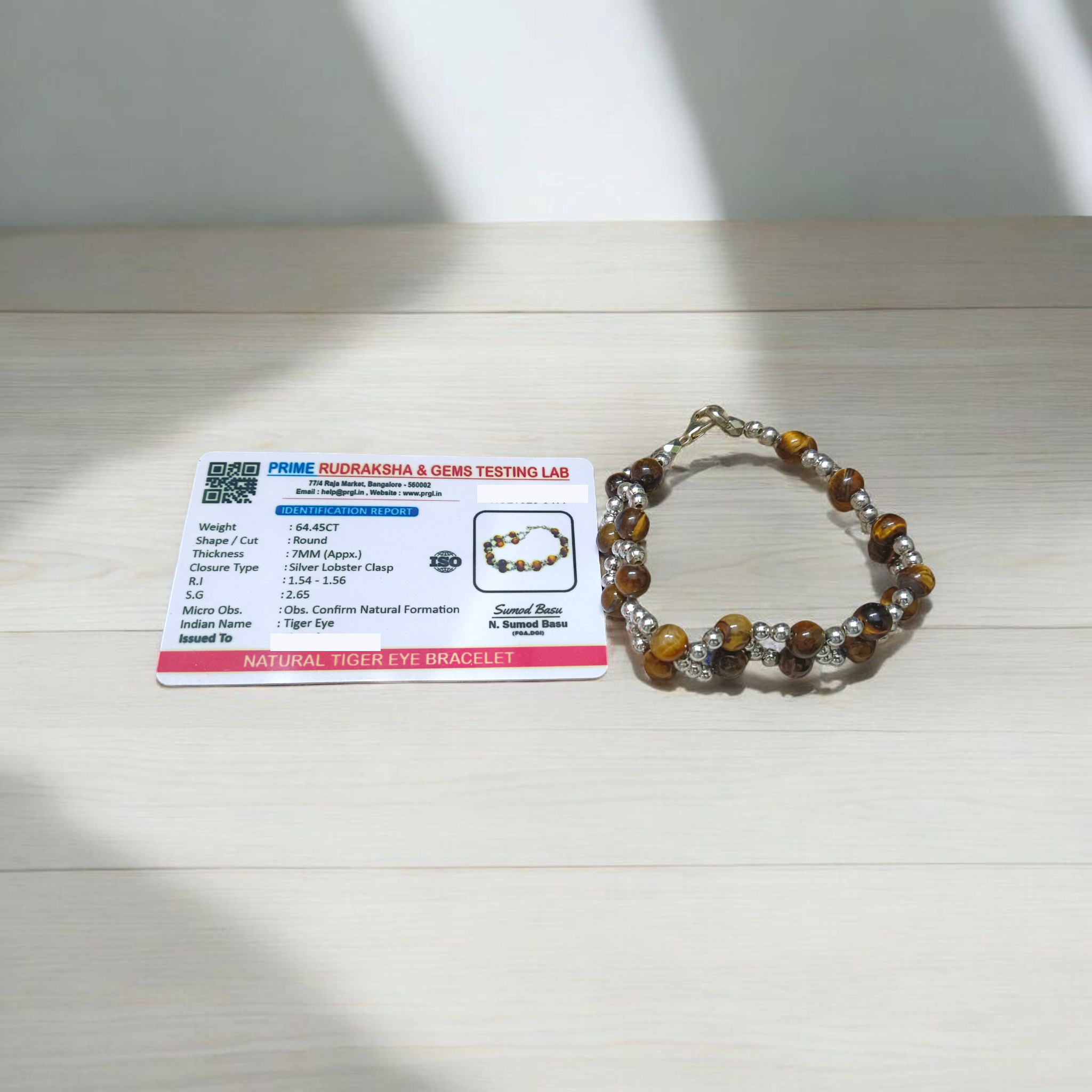 Tiger Eye Bracelet made of natural 7mm lab-certified beads with golden-brown tones placed on a white background