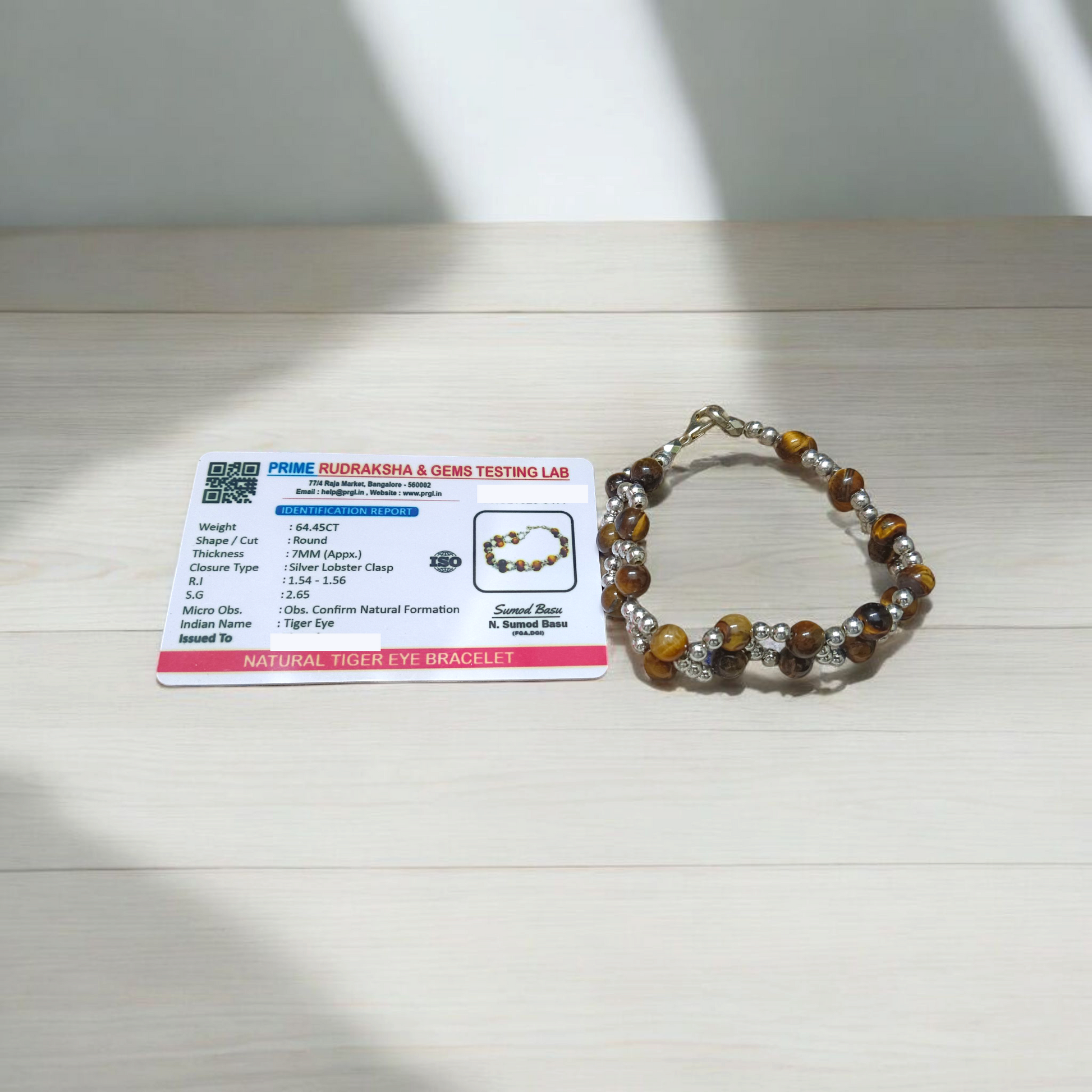Tiger Eye Bracelet made of natural 7mm lab-certified beads with golden-brown tones placed on a white background