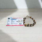 Tiger Eye Bracelet made of natural 7mm lab-certified beads with golden-brown tones placed on a white background