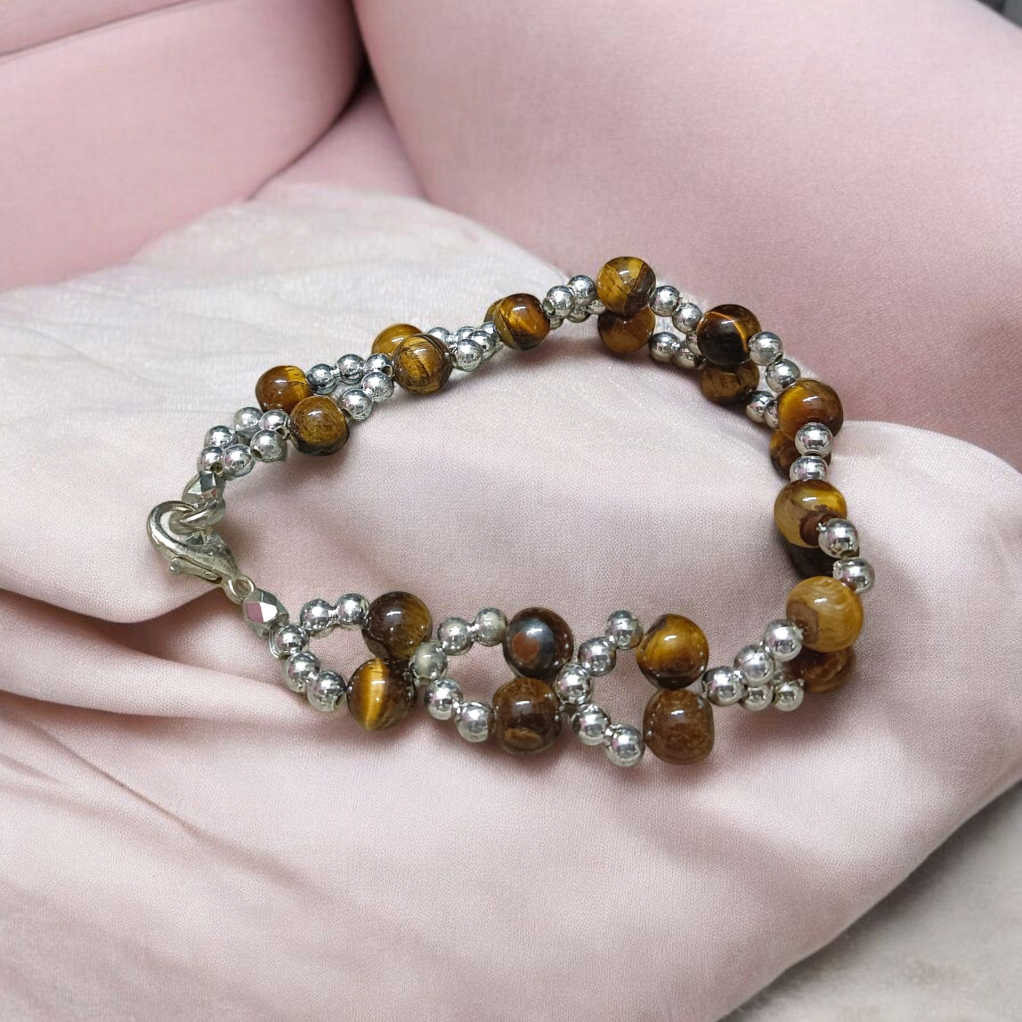 Tiger Eye Bracelet made of natural 7mm lab-certified beads with golden-brown tones placed on a white background
