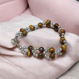 Tiger Eye Bracelet made of natural 7mm lab-certified beads with golden-brown tones placed on a white background