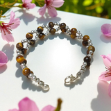 Tiger Eye Bracelet made of natural 7mm lab-certified beads with golden-brown tones placed on a white background