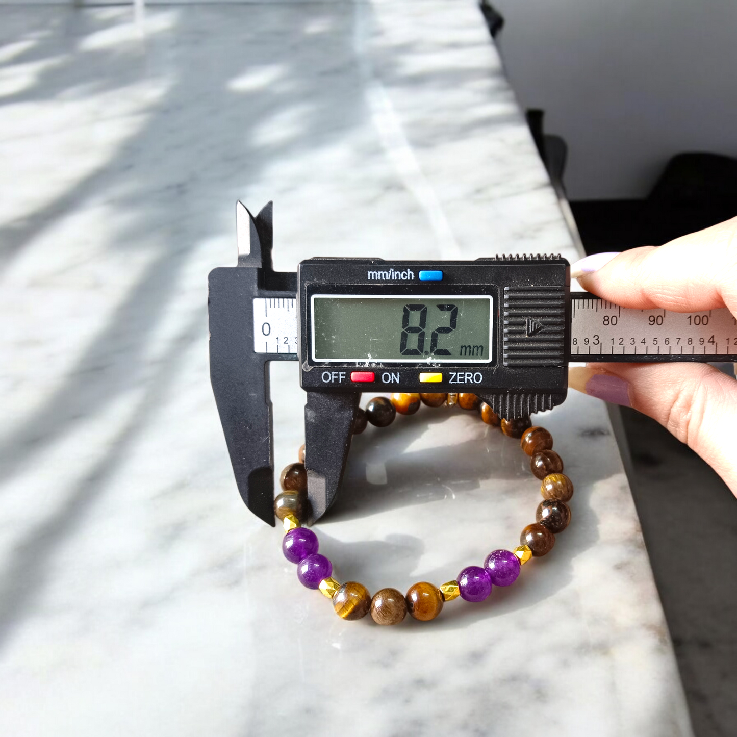 Tiger Eye and Amethyst Bracelet with 8mm polished beads on a white background, stretchable and lab certified