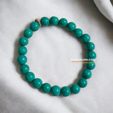 Turquoise Bracelet with smooth, 8MM natural turquoise beads, stretchable design with certificate, promoting balance, healing, and communication.