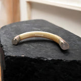 Wild Boar Tooth with U shape, encased in pure silver cap on both sides, lab-certified for authenticity, used for protection and prosperity.