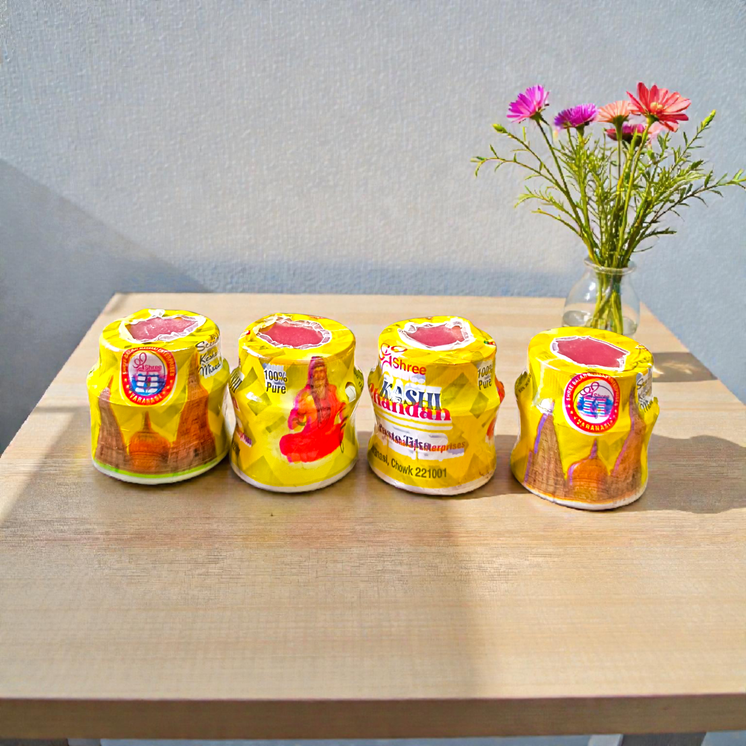 Yellow chandan paste tika container used for puja and tilak rituals