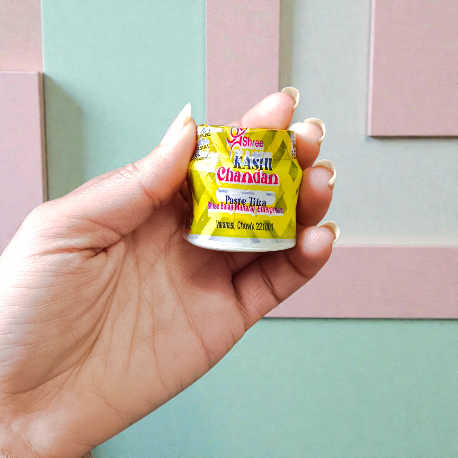 Yellow chandan paste tika container used for puja and tilak rituals