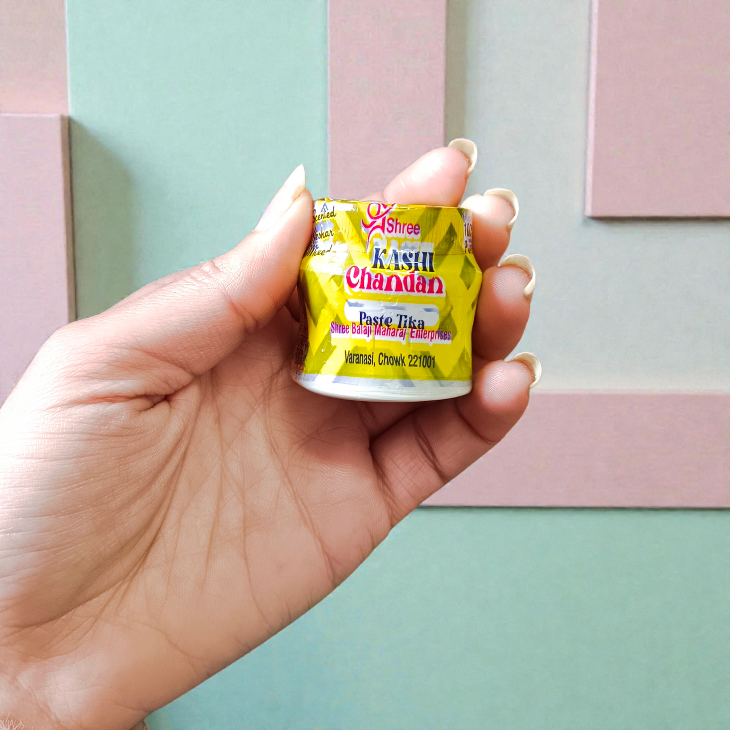 Yellow chandan paste tika container used for puja and tilak rituals