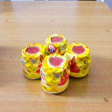 Yellow chandan paste tika container used for puja and tilak rituals