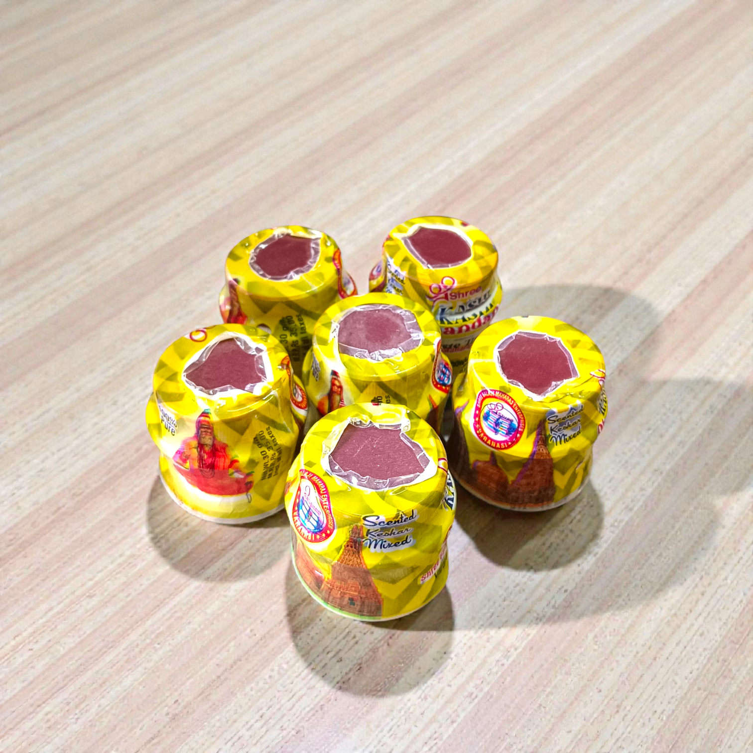 Yellow chandan paste tika container used for puja and tilak rituals